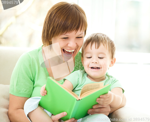 Image of Mother is reading book for her son