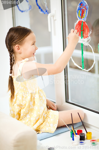 Image of Portrait of a cute girl playing with paints