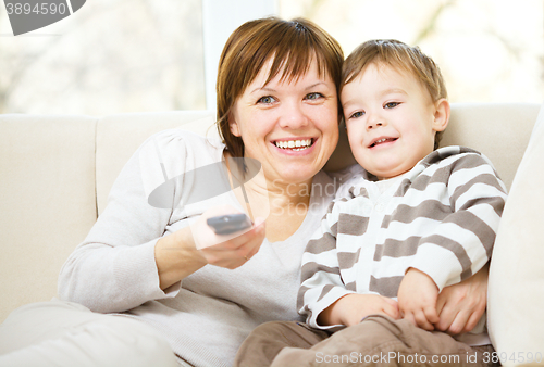 Image of Mother and her son are watching tv