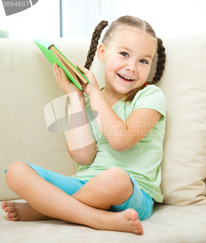 Image of Little girl reads a book