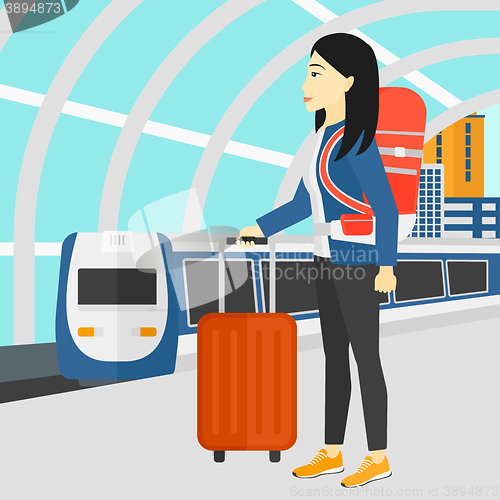 Image of Woman with suitcase on wheels and briefcase.