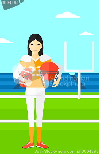 Image of Rugby player with ball and helmet in hands.