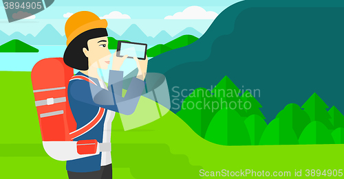 Image of Backpacker taking photo.