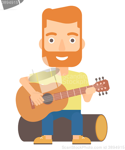 Image of Man playing guitar.