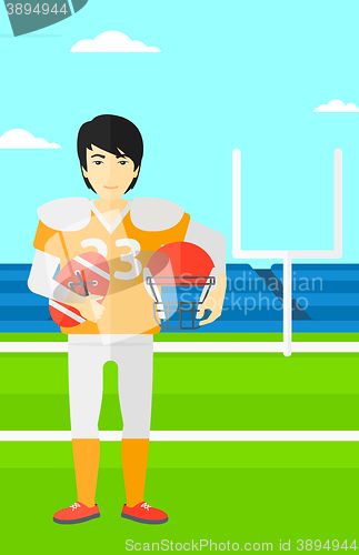 Image of Rugby player with ball and helmet in hands.