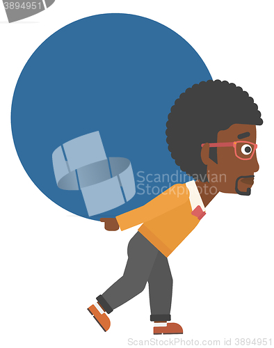 Image of Man carrying big ball.