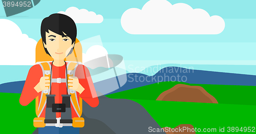 Image of Cheerful backpacker with binoculars.