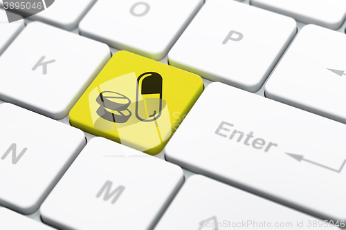 Image of Health concept: Pills on computer keyboard background
