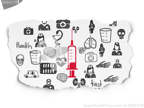 Image of Medicine concept: Syringe on Torn Paper background