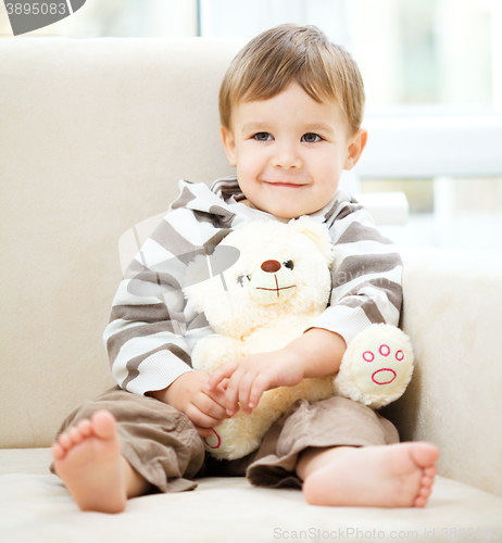 Image of Portrait of a little boy with his teddy bear