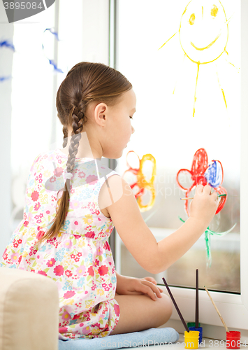 Image of Portrait of a cute girl playing with paints