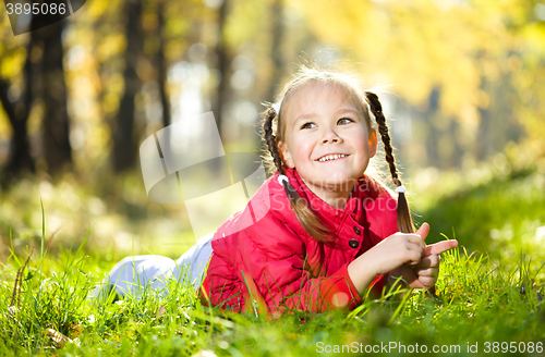 Image of Portrait of a little girl in autumn park