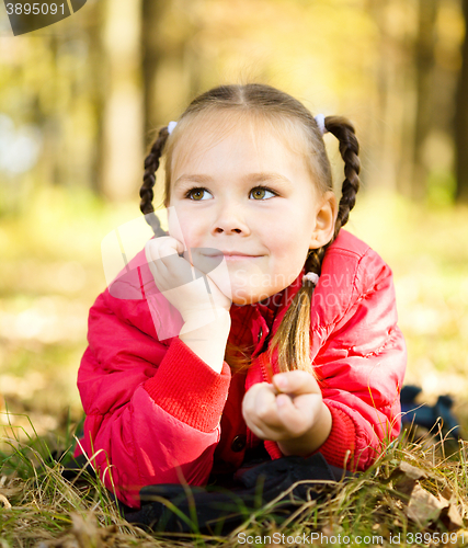 Image of Portrait of a little girl in autumn park