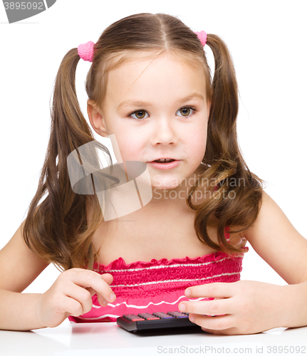 Image of Little girl is using calculator