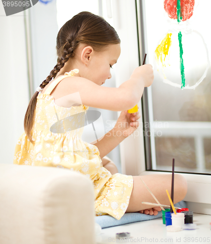 Image of Portrait of a cute girl playing with paints