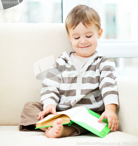 Image of Little boy is reading book