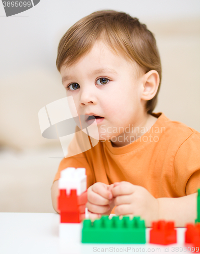 Image of Boy is playing with building blocks