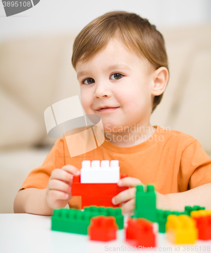 Image of Boy is playing with building blocks