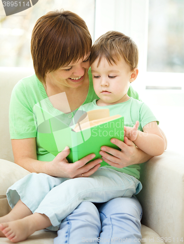 Image of Mother is reading book for her son