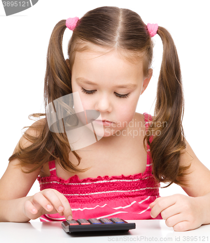 Image of Little girl is using calculator