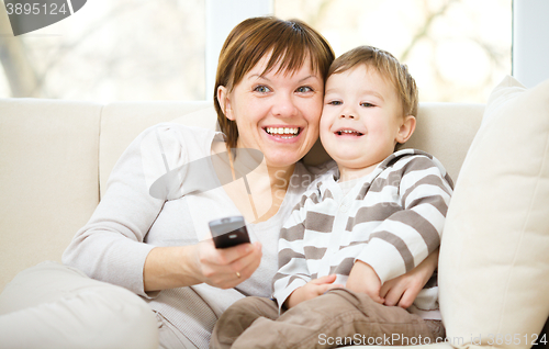 Image of Mother and her son are watching tv