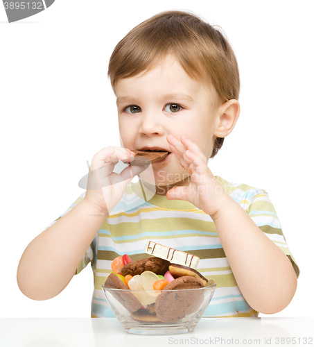 Image of Portrait of a boy with candies