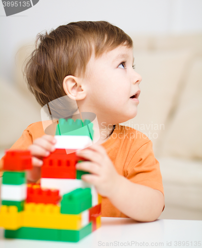 Image of Boy is playing with building blocks