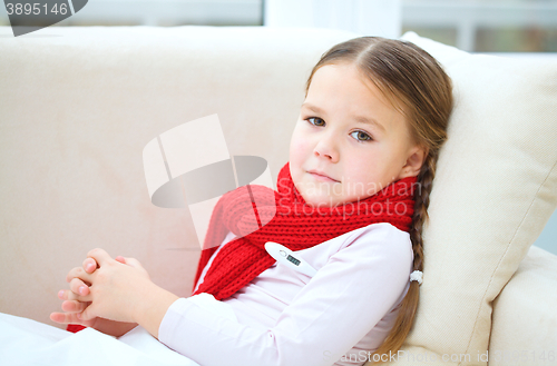 Image of Ill little girl with thermometer in her mouth