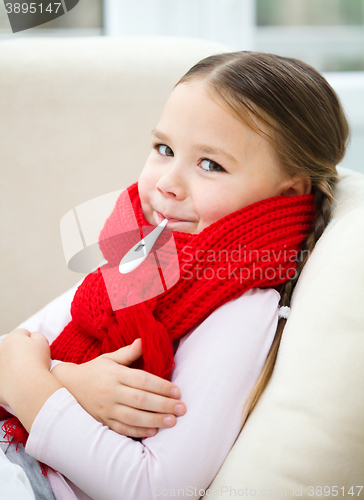 Image of Ill little girl with thermometer in her mouth