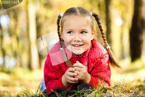 Image of Portrait of a little girl in autumn park