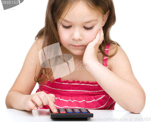 Image of Little girl is using calculator