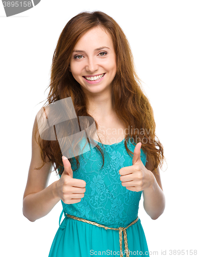 Image of Woman is showing thumb up gesture