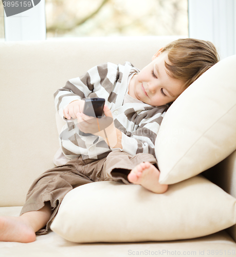 Image of Little boy is watching tv