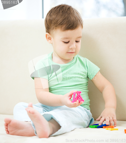 Image of Little boy playing with toys
