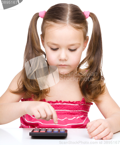 Image of Little girl is using calculator