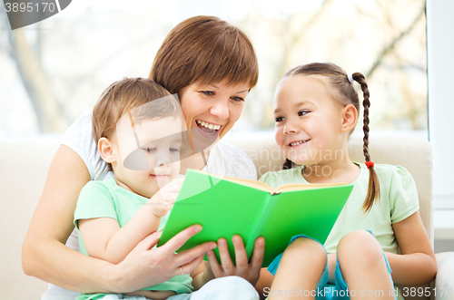 Image of Mother is reading book for her children