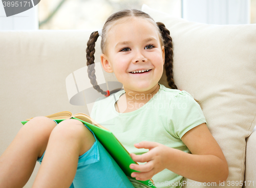 Image of Little girl reads a book