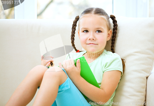 Image of Little girl reads a book