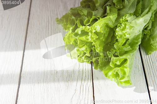 Image of lettuce salad on a wood
