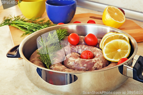 Image of Homemade pork sausage in a frying pan for a roast.