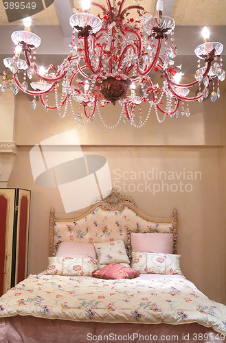 Image of bedroom with red chandelier
