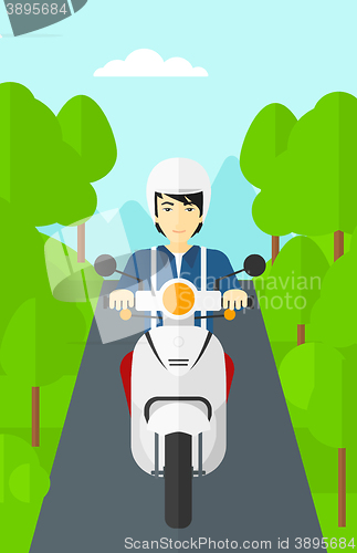 Image of Man riding scooter.