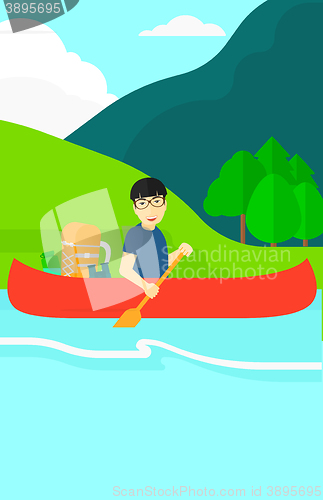 Image of Man canoeing on the river.