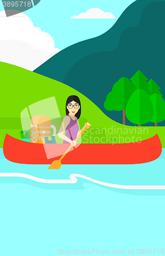 Image of Woman canoeing on the river.