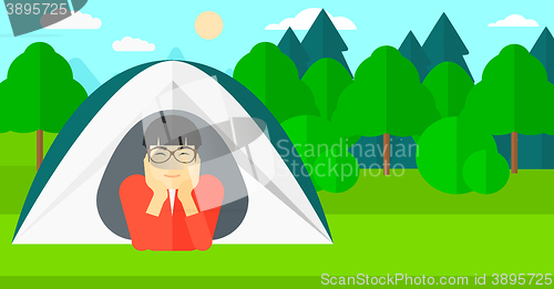 Image of Man lying in tent.