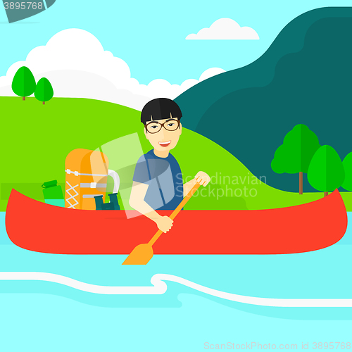 Image of Man canoeing on the river.