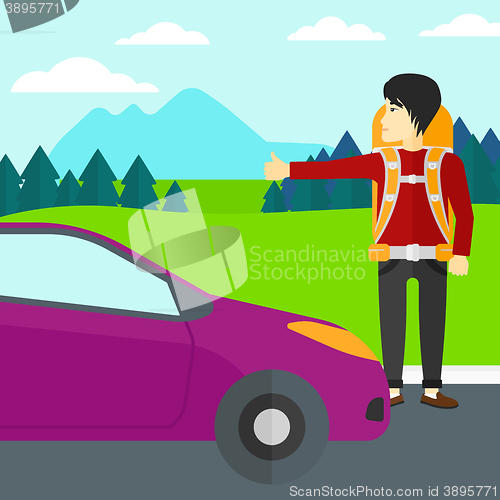 Image of Young man hitchhiking.