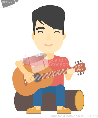 Image of Man playing guitar.