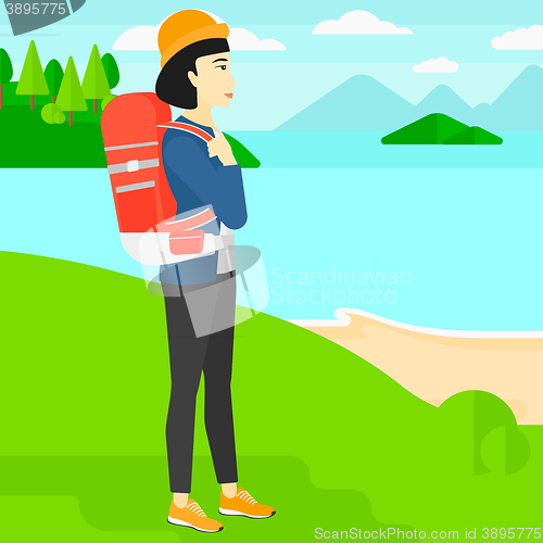 Image of Woman with backpack hiking.