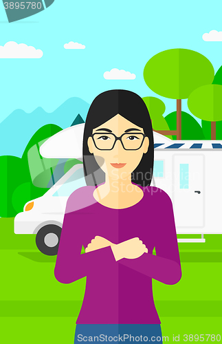 Image of Woman standing in front of motor home.